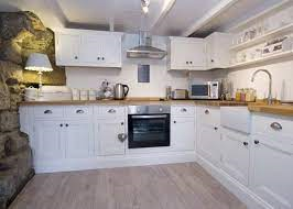 White fitted kitchen with original beams