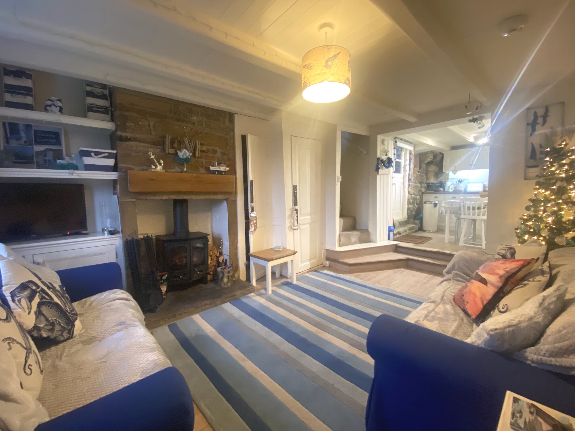 Viewley Cottage living room with original beams, stone fireplace and woodburner